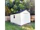 White storage shed with black roof and roll-up door at 210 W Illiana St, Orlando, FL 32806