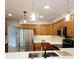 Updated kitchen featuring stainless steel appliances and wood cabinets at 210 W Illiana St, Orlando, FL 32806