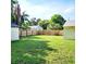 Large backyard with a wooden fence and grassy area at 210 W Illiana St, Orlando, FL 32806