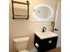 Stylish bathroom with a floating vanity, LED mirror, and updated fixtures at 210 W Illiana St, Orlando, FL 32806