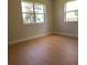 Spacious bedroom with hardwood floors and large window at 210 W Illiana St, Orlando, FL 32806