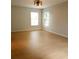 Simple bedroom with light walls and hardwood flooring at 210 W Illiana St, Orlando, FL 32806