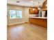 Open concept dining area with wood flooring and kitchen view at 210 W Illiana St, Orlando, FL 32806