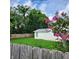 Backyard with shed, wooden fence, and flowering bush at 210 W Illiana St, Orlando, FL 32806