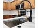 Modern kitchen sink with a black and gold faucet and quartz countertop at 210 W Illiana St, Orlando, FL 32806