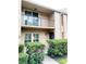 Exterior view of a two-story condo with balcony and landscaping at 1019 Grove St # 85, Maitland, FL 32751