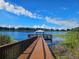 Expansive wooden dock extending over tranquil lake with gazebo at 2404 Pickford Cir, Apopka, FL 32703