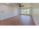 Simple bedroom with hardwood floors and a large window at 8375 Ne Jacksonville Rd, Ocala, FL 34479