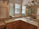 Bathroom with double sinks, large mirror, and updated vanity at 1889 Blythewood Loop, The Villages, FL 32162