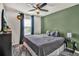 Bedroom with gray bedding and ceiling fan at 2720 Monticello Way, Kissimmee, FL 34741