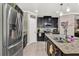 Modern kitchen with stainless steel appliances and granite counters at 2720 Monticello Way, Kissimmee, FL 34741