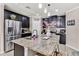 Kitchen island with granite countertop and sink at 2720 Monticello Way, Kissimmee, FL 34741