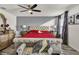Main bedroom with red bedding and gray accent wall at 2720 Monticello Way, Kissimmee, FL 34741