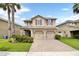 Two-story house with two-car garage and palm trees at 2720 Monticello Way, Kissimmee, FL 34741