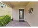 Covered front porch with decorative door and brick flooring at 2720 Monticello Way, Kissimmee, FL 34741