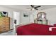 Main bedroom with red bedding and ensuite bathroom at 2720 Monticello Way, Kissimmee, FL 34741