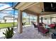 Covered patio with seating area, pavers, and grill at 2720 Monticello Way, Kissimmee, FL 34741
