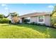 Exterior view of a house with a grassy lawn under a bright sky at 1955 Avenue D, Mulberry, FL 33860