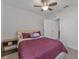 Cozy bedroom with a queen-size bed, nightstand, and ceiling fan at 2557 Shamrock St, Tavares, FL 32778