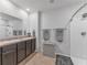 Bathroom with double sinks, shower, and linen storage at 2557 Shamrock St, Tavares, FL 32778