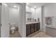 Main bathroom with toilet and double vanity at 2557 Shamrock St, Tavares, FL 32778