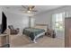 Large main bedroom with a king-size bed, ceiling fan, and plenty of space at 2557 Shamrock St, Tavares, FL 32778