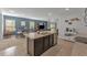 Modern kitchen island with breakfast bar, stainless steel appliances, and ample cabinet space at 2557 Shamrock St, Tavares, FL 32778
