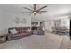 Spacious living room with a comfortable leather couch and large windows at 2557 Shamrock St, Tavares, FL 32778