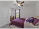 Bright bedroom with a queen-size bed, dresser, and ceiling fan at 2557 Shamrock St, Tavares, FL 32778