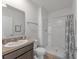 Clean bathroom with a walk-in shower, vanity, and toilet at 2557 Shamrock St, Tavares, FL 32778