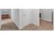 Hallway with carpet flooring and access to laundry at 2557 Shamrock St, Tavares, FL 32778