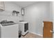 Laundry room with washer, dryer, and shelving at 2557 Shamrock St, Tavares, FL 32778