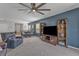 Open living area with a large TV, built-in shelving, and plenty of natural light at 2557 Shamrock St, Tavares, FL 32778