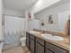 Bathroom with double sinks and patterned shower curtain at 2557 Shamrock St, Tavares, FL 32778