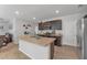 Modern kitchen with island and dark brown cabinets at 2557 Shamrock St, Tavares, FL 32778