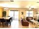 Spacious living room with a leather sofa, dining table, and pool view at 1402 Wexford Way, Davenport, FL 33896