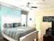 Large bedroom with king bed, light blue walls, and ensuite bathroom at 1402 Wexford Way, Davenport, FL 33896
