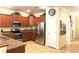 Modern kitchen featuring stainless steel appliances and wood cabinets at 1402 Wexford Way, Davenport, FL 33896