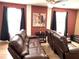 Comfortable living room with brown leather recliners and a large TV at 1402 Wexford Way, Davenport, FL 33896