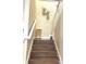 Elegant staircase with wood steps and a gold wall accent at 1402 Wexford Way, Davenport, FL 33896