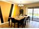 Dining room with a view of the pool and modern decor at 1402 Wexford Way, Davenport, FL 33896
