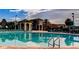 Resort-style pool with plenty of lounge chairs and a clubhouse at 1402 Wexford Way, Davenport, FL 33896