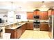Spacious kitchen with stainless steel appliances and granite countertops at 1402 Wexford Way, Davenport, FL 33896