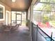 Covered patio with table and chairs near the pool at 1402 Wexford Way, Davenport, FL 33896