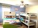 Bunk beds with Paw Patrol bedding, ceiling fan, and light blue walls at 1402 Wexford Way, Davenport, FL 33896