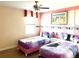 Twin beds with Frozen bedding, ceiling fan and pink walls at 1402 Wexford Way, Davenport, FL 33896