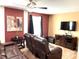 Comfortable living room with brown leather recliners and a large TV at 1402 Wexford Way, Davenport, FL 33896
