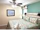 King-size bed with floral bedding and ceiling fan at 1402 Wexford Way, Davenport, FL 33896