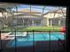 Screened pool and spa with red lounge chairs at 1402 Wexford Way, Davenport, FL 33896