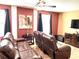 Comfortable living room with brown leather recliners and a large TV at 1402 Wexford Way, Davenport, FL 33896